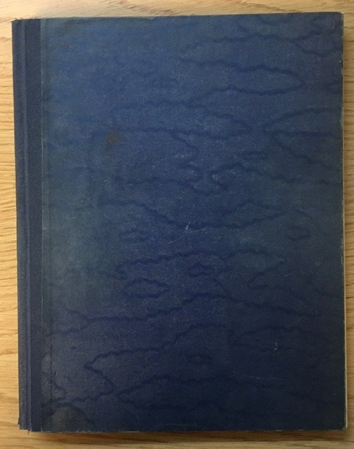 An aged and well-worn front cover of a blue 'Eureka' notebook.