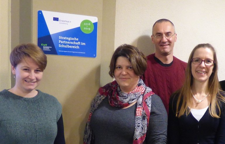 project team members in front of ErasmusPlus plaque at Karlsruhe University, Germany