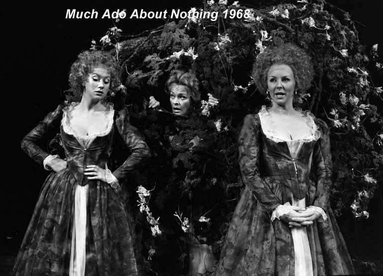 Much Ado About Nothing, Holte, 1968. Three ladies, two clearly in eighteenth-century costume, are facing the audience. The one on the left, Hero, has her hands on her hips and is leaning towards the central figure (her maid) who is telling her something. The lady on the right (Beatrice) is clearly overhearing, as she stands with her hands clasped at her waist and her mouth open.