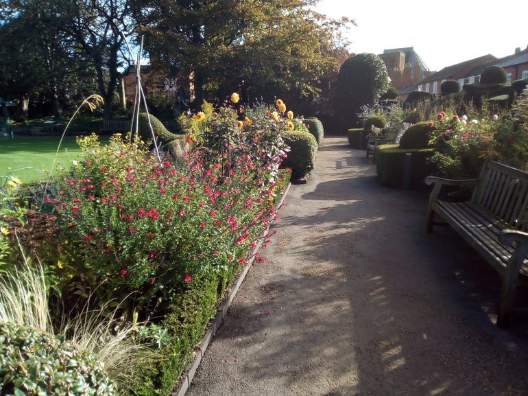 Formal framework of yew filed with perennial flowers