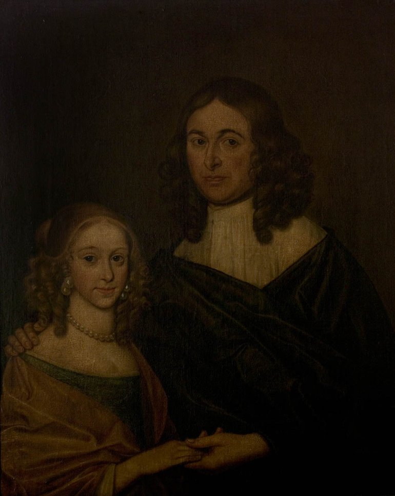 A very dark picture shows a young man with "cavalier" hair and an embroidered white shirt, and a young lady also with long light-brown curly hair, wearing a brownish low-cut dress and a choker. The couple. are holding hands (her right in his left), and look very serious.