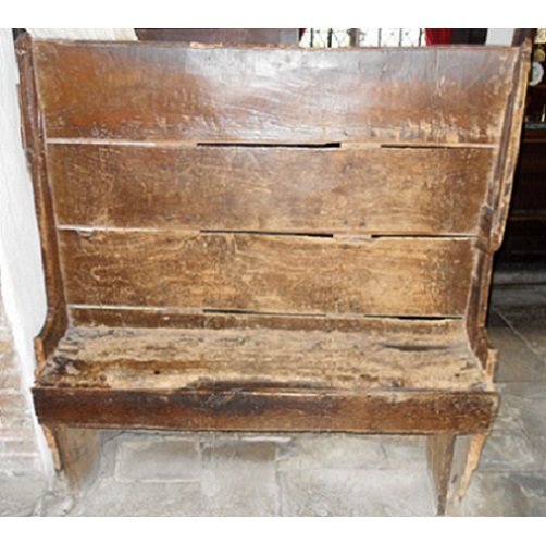 A very rough  small settle, with panel sides down to the floor rather than legs, cut back just above seat level to provide a support for the three-plank back  The seat is covered in scuffed leather The settle would hold two people in close proximity.
