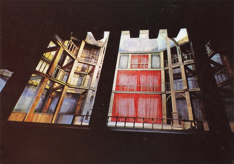 The interior of the modern Globe, showing the three levels of "boxes"  and the stage with  railing separating it from the pit.