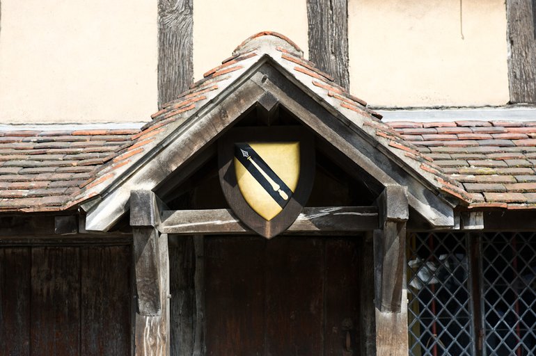 The Gable over the door of Shakespeare's Birthplace, with the shield from his coat of arms mounted with a wooden border centrally in the triangle of the gable.