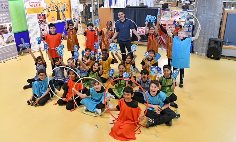 Primary aged children and Ben Cajee in Birmingham Library launching Shakespeare Week 2022 with Bollywood Dance and Circus Skills.