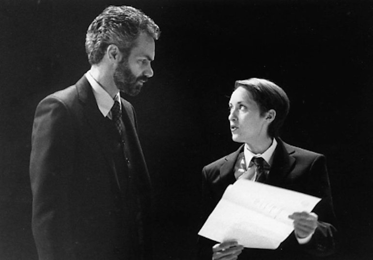 The Merchant of Venice Royal Shakespeare Company, 2008 A young-ish bearded man (Antonio?) looks at a younger, shorter man (Portia as a lawyer?) who is holding a sheet of paper which appears to carry bad news for the older man. Both are in modern dress.