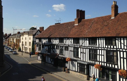 A view of a Stratford street, with a large timber-framed building in the foreground.